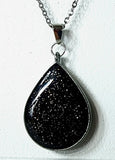 Polymer clay earring and necklace gift set features polymer clay studs and matching necklace. The polymer clay studs and necklace pendant both feature black sparkle.