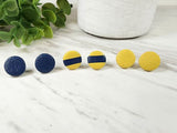 These cute and stylish polymer clay stud earrings are lightweight, eclectic and sure to make a statement. This set features 3 cute round studs in navy & mustard.   This set includes 3 pairs of polymer clay stud earrings.