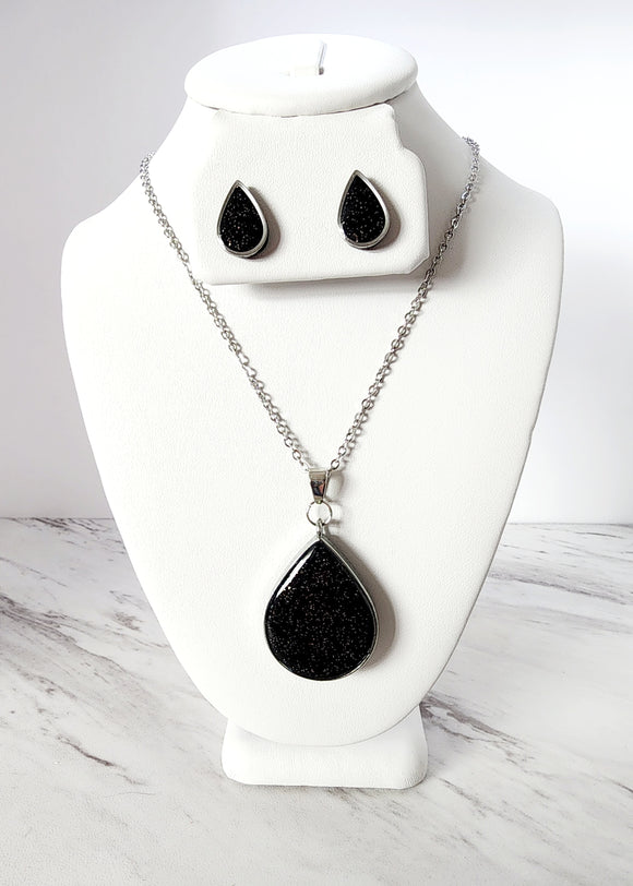 Polymer clay earring and necklace gift set features polymer clay studs and matching necklace. The polymer clay studs and necklace pendant both feature black sparkle.