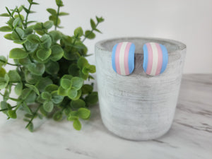 These cute and stylish polymer clay rainbow earrings are lightweight, eclectic and sure to make a statement. With their pastel colours, they are sure to bring your day joy & happiness! They curl up under your ear with comfort. I like to call them a Huggie, simply because they hug your ears! These Rainbow huggies represent the transgender community. Whether you identify as such, you can show your support or simply wear them because they are gorgeous. Finished with titanium posts for sensitive ears